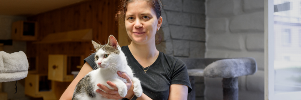 An animal welfare professional holding a cat
